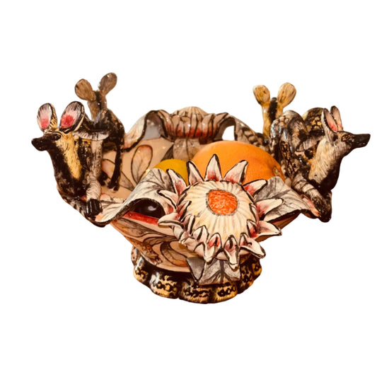 Decorative ceramic bowl with animal and floral designs