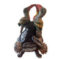 Decorative sculpture of two parrots on a branch with a wreath of flowers.