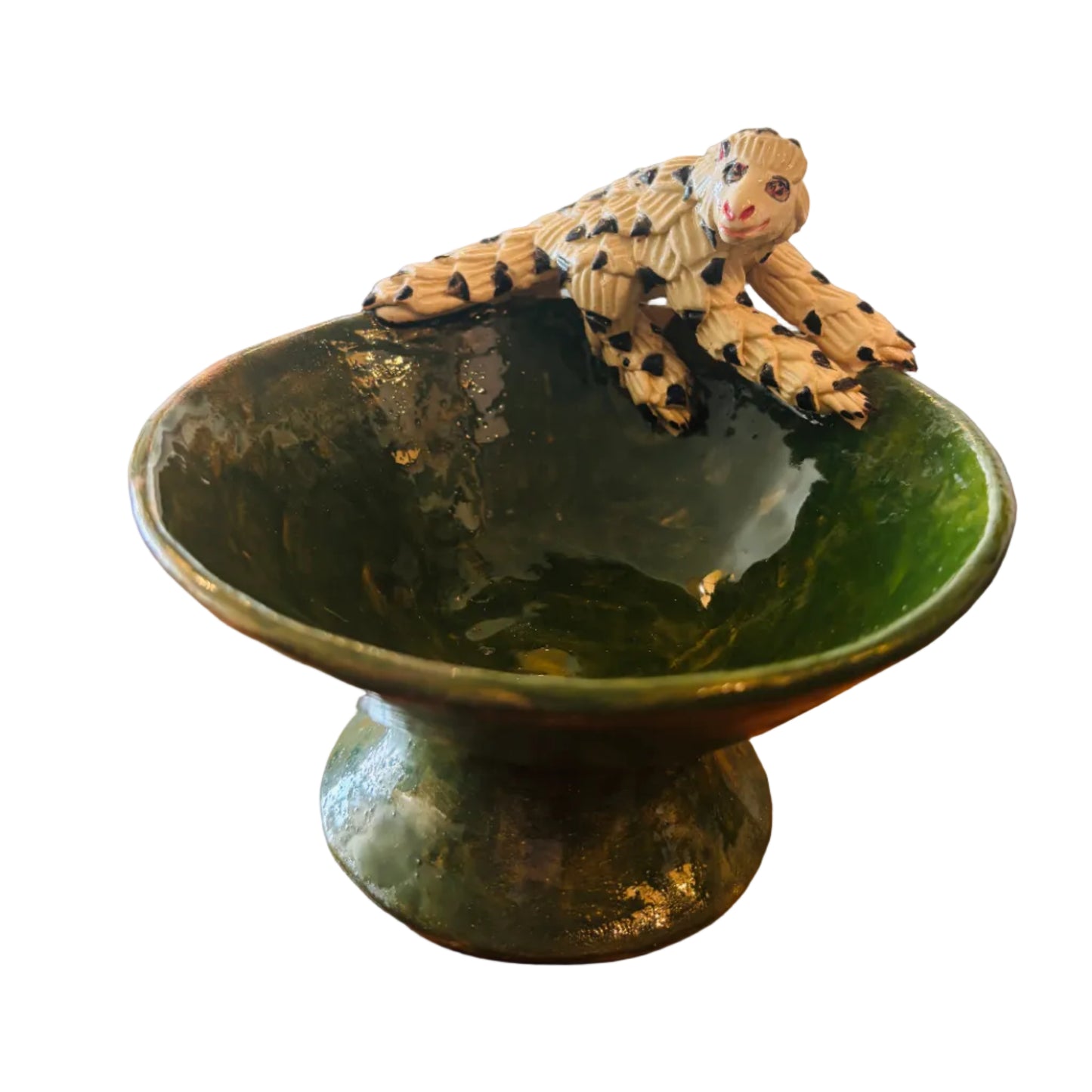 Green ceramic bowl with a decorative pangolin figurine 