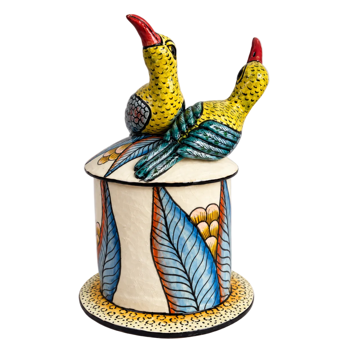 A hand-painted ceramic decorative jar with a lid, featuring two yellow and blue birds and with red beaks perched on top. The jar is decorated with blue, orange, and yellow leaf patterns on a cream-colored base, set against a neutral gray background.