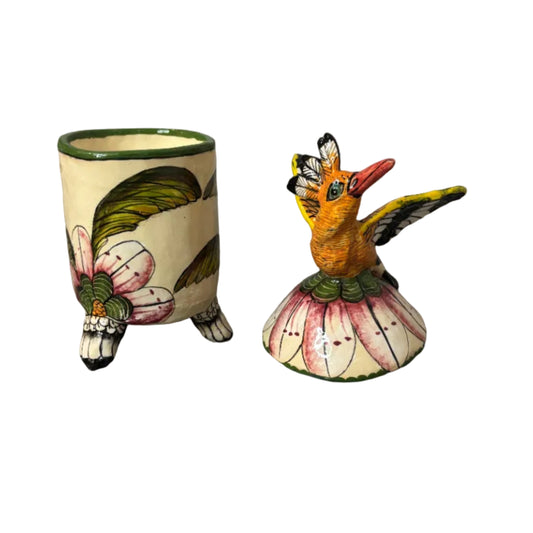 Decorative container with a lid. Atop the lid sits a bird.  Hand painted florals. Ceramic art. Scented candle inside. 