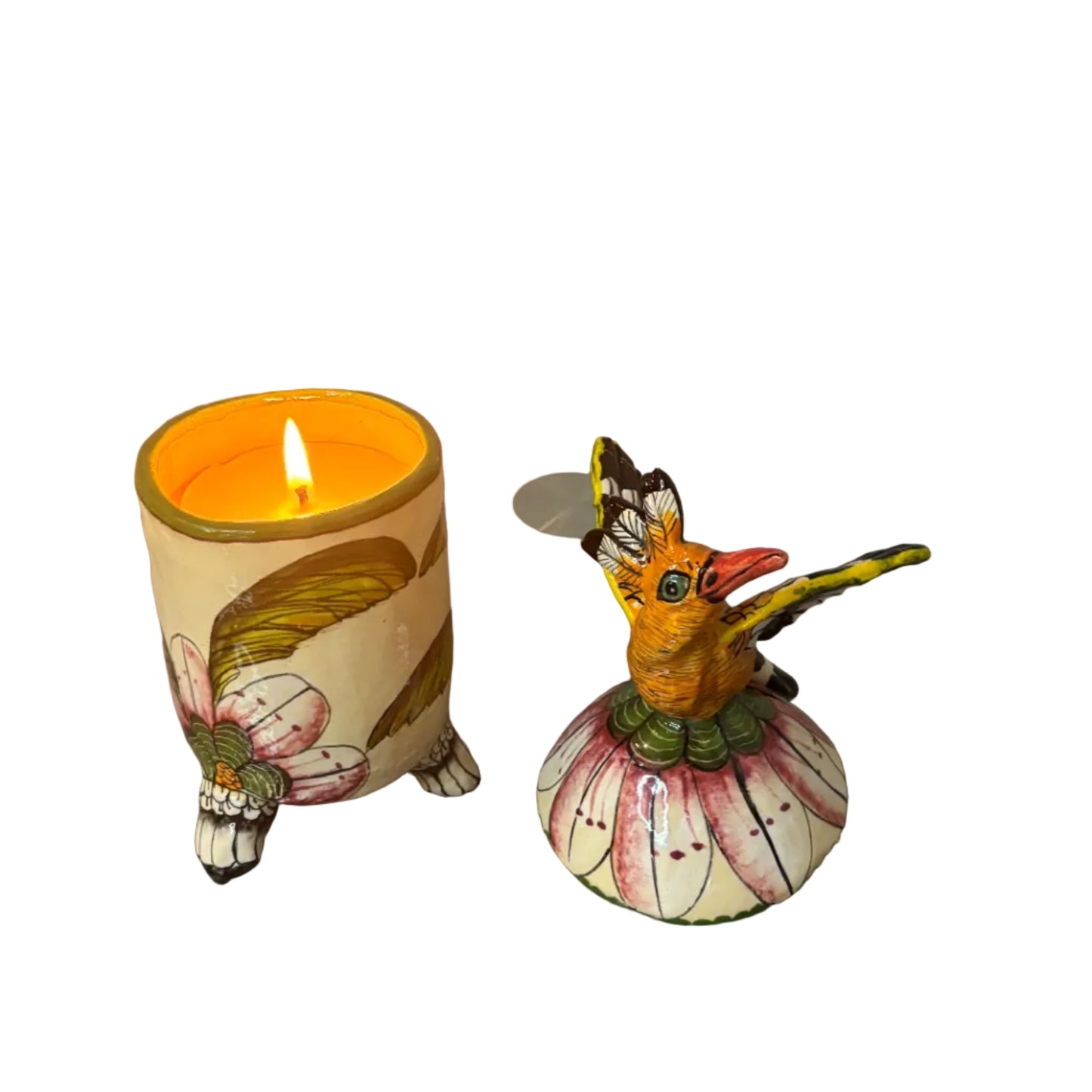 Decorative container with a lid. Atop the lid sits a bird.  Hand painted florals. Ceramic art. Scented candle inside. 