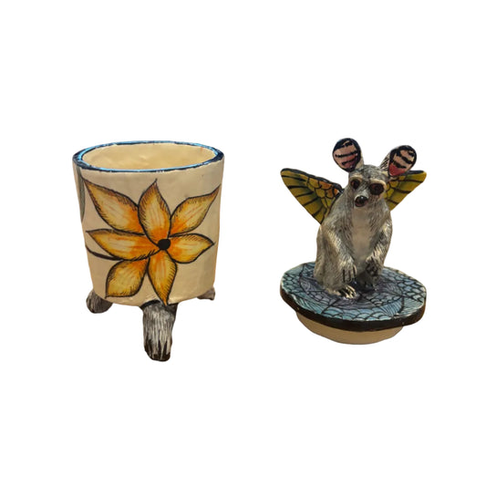 Handcrafted ceramic trinket box features a whimsical bushbaby perched atop the lid, complete with beautifully painted butterfly wings.