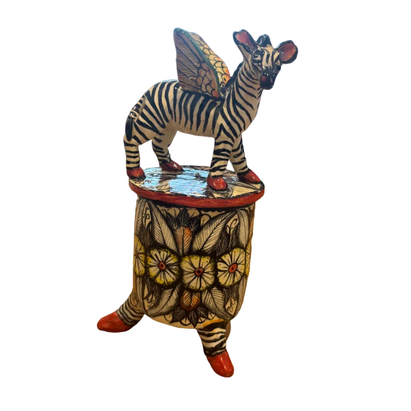 A hand-painted zebra figurine atop a lid of a trinket container. Ceramic art.  