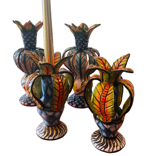 Decorative candle holders with colorful leaf designs. 
