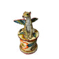 A hand-painted ceramic figurine of a leopard with wings, mounted on a matching cylindrical pedestal decorated with floral and bird motifs, set against a plain white background.