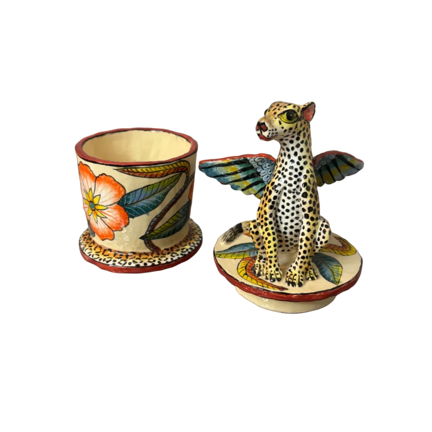Trinket container. Winged leopard sits on top of the lid.  Jar is painted with bright botanicals.  